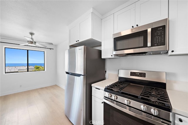 33771 Copper Lantern St, Dana Point, CA 92629 - kitchen with stainless steel appliances, light countertops, a ceiling fan, white cabinets, and light wood-style flooring