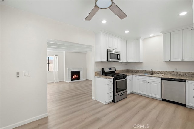 33771 Copper Lantern St, Dana Point, CA 92629 - kitchen featuring appliances with stainless steel finishes, light wood-style flooring, a ceiling fan, white cabinetry, and recessed lighting