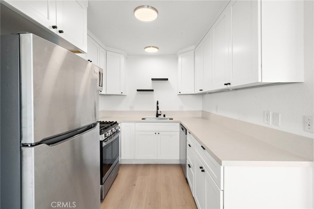 33771 Copper Lantern St, Dana Point, CA 92629 - kitchen featuring appliances with stainless steel finishes, white cabinetry, light wood-style flooring, and light countertops
