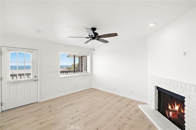 33771 Copper Lantern St, Dana Point, CA 92629 - unfurnished living room featuring a brick fireplace, wood finished floors, ceiling fan, and recessed lighting