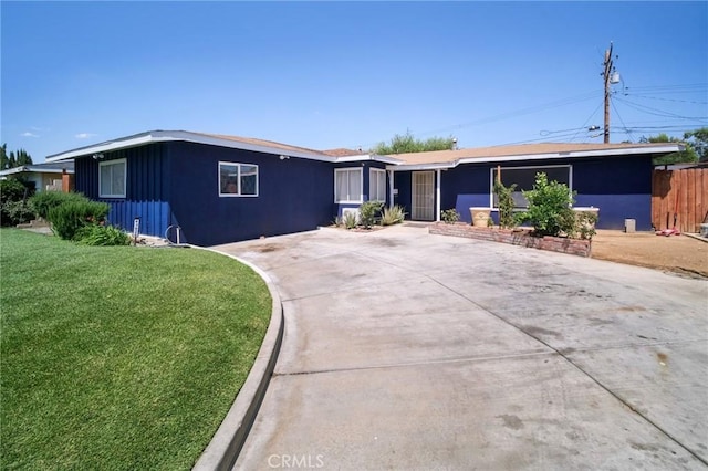 43926 3rd St E, Lancaster, CA 93535 - ranch-style home featuring a front lawn, concrete driveway, and board and batten siding