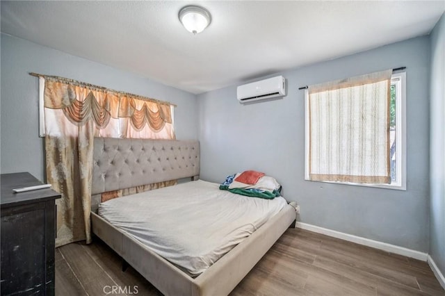 43926 3rd St E, Lancaster, CA 93535 - bedroom with a wall mounted air conditioner and wood finished floors