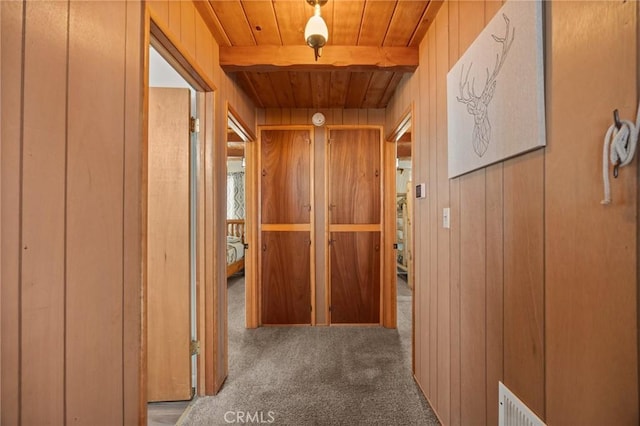 130 Maple Ln, Sugarloaf, CA 92386 - hall with carpet floors, a wood ceiling with exposed beams, and wooden walls