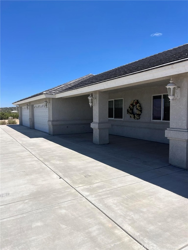 325 Canyon Rd, Pinon Hills, CA 92372 - view of home's exterior with stucco siding and driveway