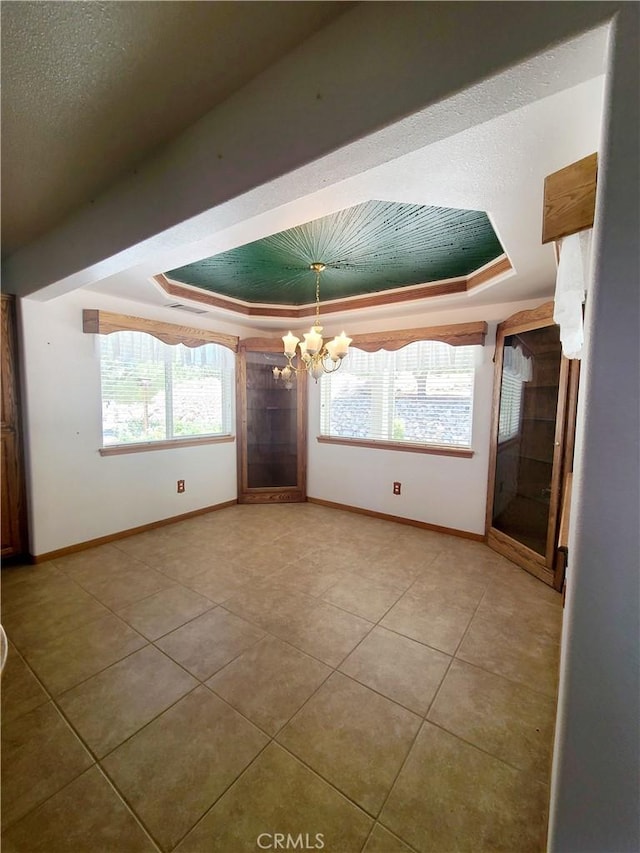 325 Canyon Rd, Pinon Hills, CA 92372 - unfurnished room with a raised ceiling, a chandelier, and light tile patterned floors