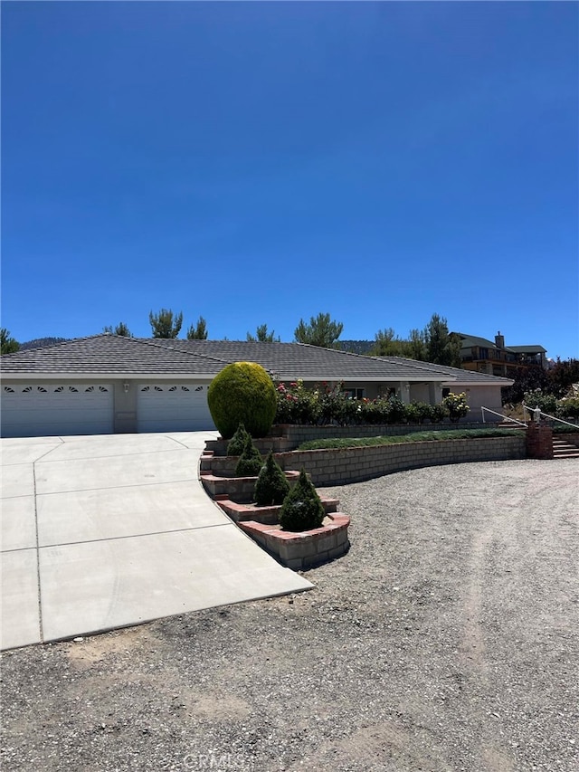 325 Canyon Rd, Pinon Hills, CA 92372 - ranch-style home featuring a garage and concrete driveway