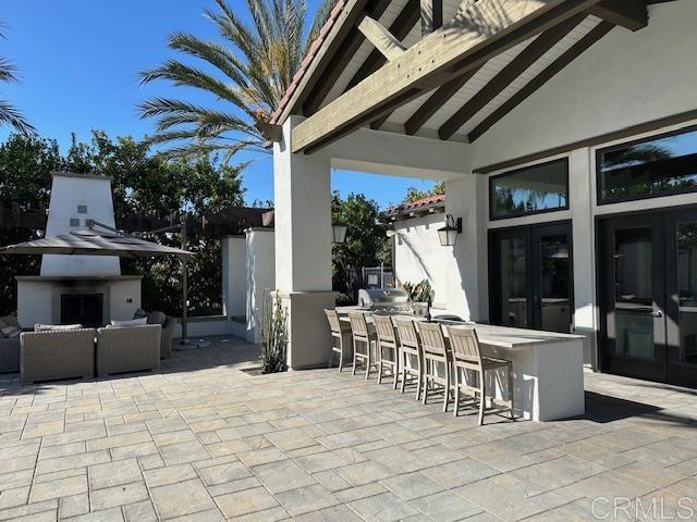 2527 Wellspring St, Carlsbad, CA 92010 - view of patio with an outdoor living space with a fireplace and french doors