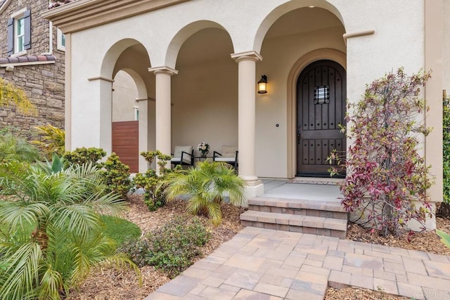 2527 Wellspring St, Carlsbad, CA 92010 - doorway to property with stucco siding and a porch