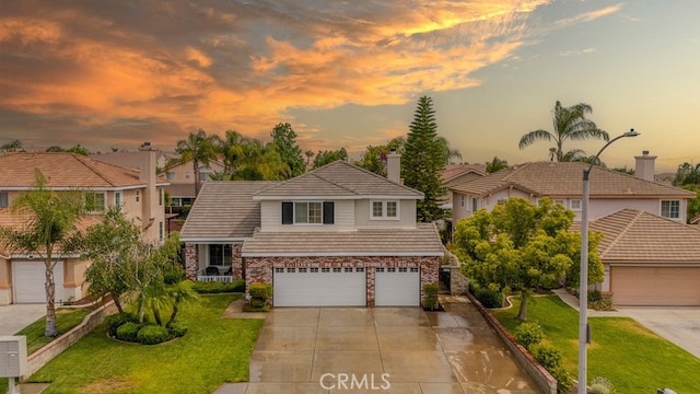 20770 Stony Brook Cir, Riverside, CA 92508 - traditional-style house featuring a tile roof, a garage, a front yard, stone siding, and driveway