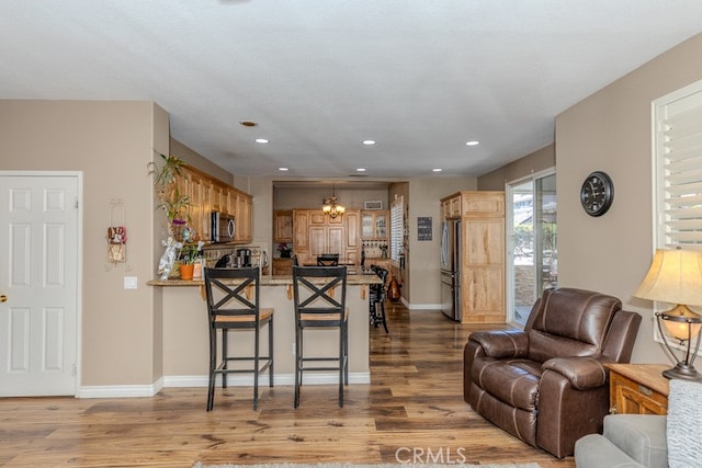 20770 Stony Brook Cir, Riverside, CA 92508 - living room with a chandelier, wood finished floors, and recessed lighting