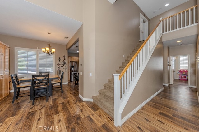 20770 Stony Brook Cir, Riverside, CA 92508 - dining area featuring wood finished floors, stairs, a chandelier, a high ceiling, and recessed lighting