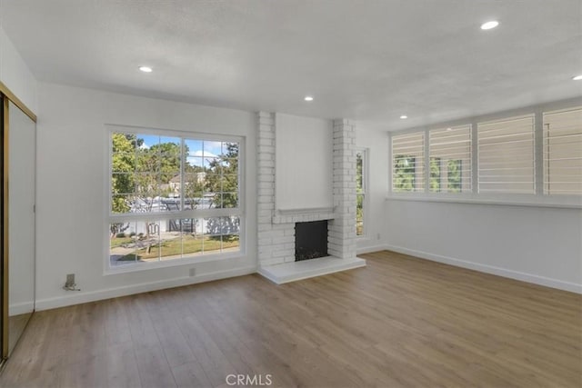 6 Mandrake Way, Irvine, CA 92612 - unfurnished living room featuring a brick fireplace, wood finished floors, and recessed lighting