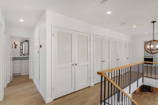 6 Mandrake Way, Irvine, CA 92612 - corridor featuring an upstairs landing, light wood-style flooring, a chandelier, and recessed lighting