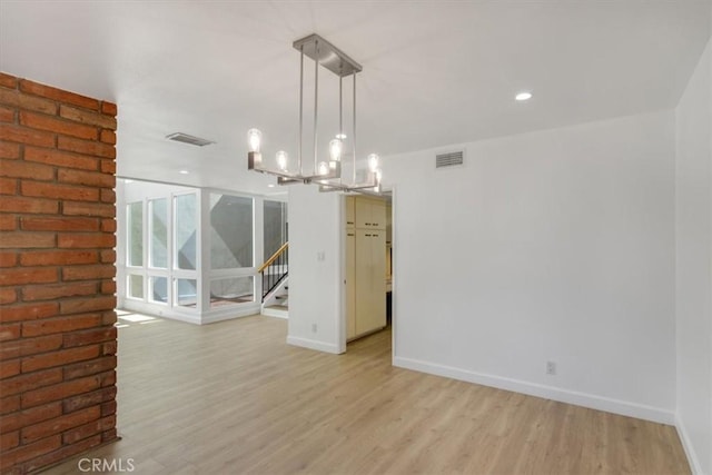 6 Mandrake Way, Irvine, CA 92612 - spare room with a chandelier, light wood-style flooring, and stairway