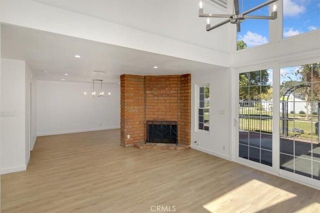 6 Mandrake Way, Irvine, CA 92612 - unfurnished living room with a chandelier, light wood-type flooring, a fireplace, and recessed lighting