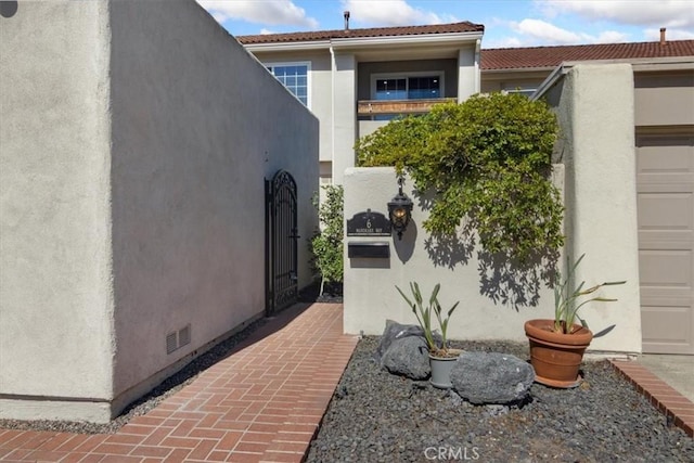 6 Mandrake Way, Irvine, CA 92612 - view of exterior entry featuring stucco siding and a garage
