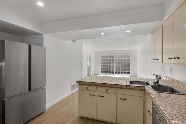 6 Mandrake Way, Irvine, CA 92612 - kitchen with appliances with stainless steel finishes, cream cabinetry, a peninsula, light wood finished floors, and recessed lighting