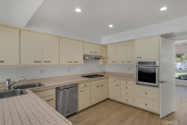 6 Mandrake Way, Irvine, CA 92612 - kitchen with cream cabinets, stainless steel appliances, under cabinet range hood, light wood-style flooring, and recessed lighting