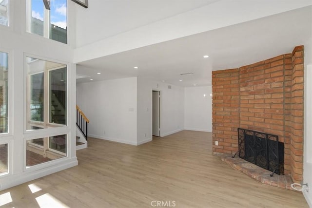 6 Mandrake Way, Irvine, CA 92612 - unfurnished living room featuring stairway, a fireplace, wood finished floors, and recessed lighting