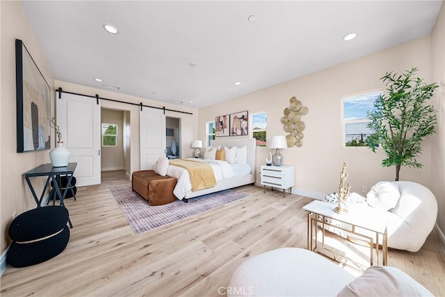 2709 Cogswell Rd Unit A, El Monte, CA 91732 - bedroom featuring a barn door, light wood-style flooring, and recessed lighting