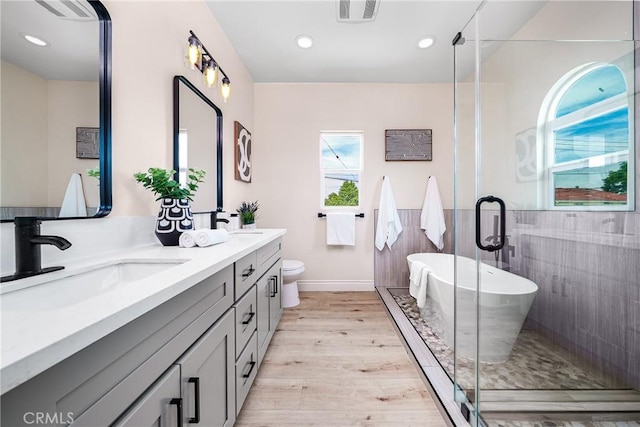2709 Cogswell Rd Unit A, El Monte, CA 91732 - bathroom with double vanity, a soaking tub, wood finished floors, a shower stall, and recessed lighting