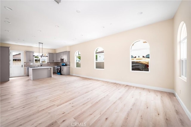 2709 Cogswell Rd Unit B, El Monte, CA 91732 - unfurnished living room with light wood finished floors and baseboards