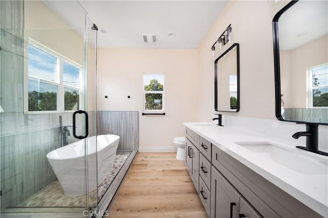 2709 Cogswell Rd Unit B, El Monte, CA 91732 - bathroom featuring healthy amount of natural light, double vanity, a freestanding bath, and wood finished floors