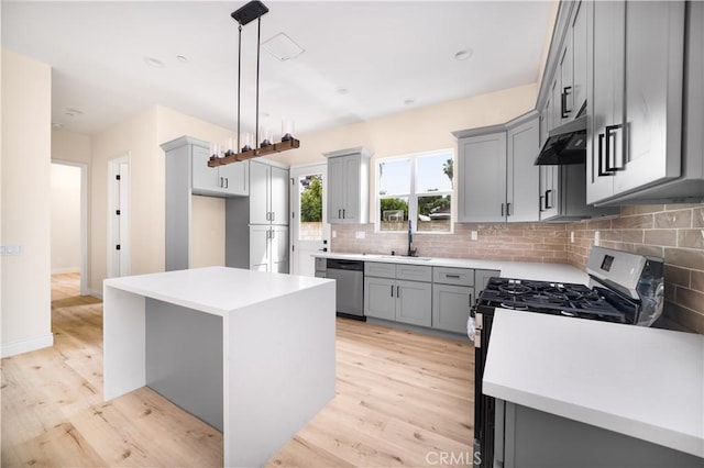 2709 Cogswell Rd Unit B, El Monte, CA 91732 - kitchen with gray cabinetry, gas range oven, light wood finished floors, and a kitchen island