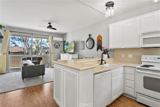 20191 Cape Coral Ln Unit 3-206, Huntington Beach, CA 92646 - kitchen with white appliances, ceiling fan, a peninsula, and white cabinets