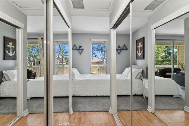 20191 Cape Coral Ln Unit 3-206, Huntington Beach, CA 92646 - bedroom with multiple windows, two closets, and wood finished floors