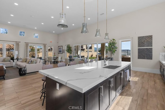 20552 Galloway, Saugus, CA 91350 - kitchen featuring open floor plan, light wood-style flooring, a towering ceiling, recessed lighting, and hanging light fixtures
