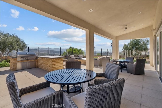 20552 Galloway, Saugus, CA 91350 - view of patio / terrace featuring outdoor dining space, an outdoor kitchen, a ceiling fan, a mountain view, and an outdoor hangout area