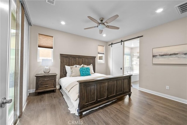 20552 Galloway, Saugus, CA 91350 - bedroom featuring a barn door, dark wood-style floors, recessed lighting, ensuite bathroom, and ceiling fan