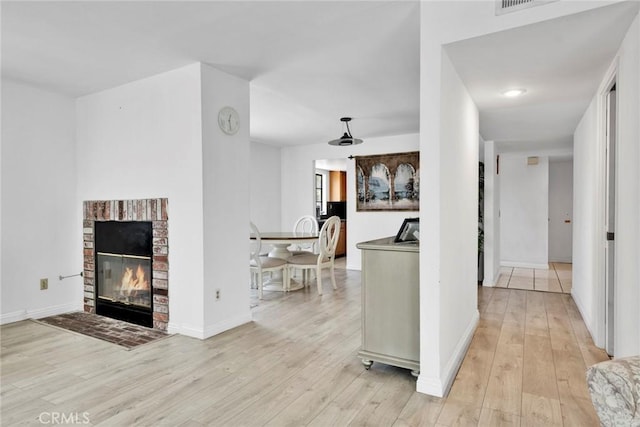 1029 S Reservoir St, Pomona, CA 91766 - living room with light wood finished floors and a fireplace