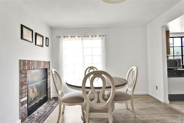 1029 S Reservoir St, Pomona, CA 91766 - dining space featuring a brick fireplace and wood finished floors