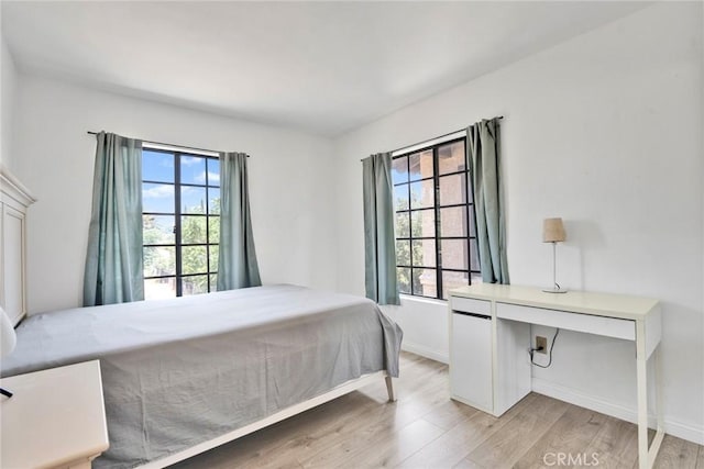 1029 S Reservoir St, Pomona, CA 91766 - bedroom featuring multiple windows and light wood finished floors