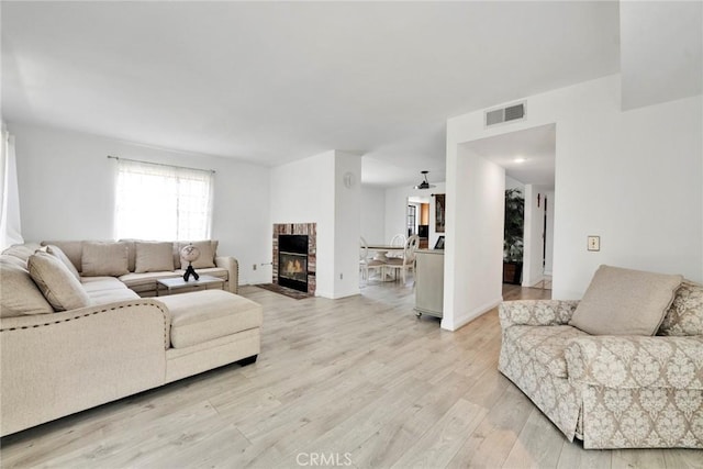 1029 S Reservoir St, Pomona, CA 91766 - living room featuring light wood-style flooring and a fireplace