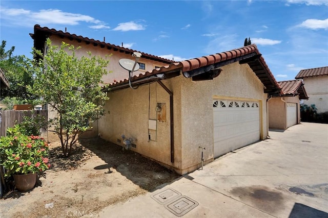1029 S Reservoir St, Pomona, CA 91766 - view of property exterior featuring stucco siding, an attached garage, a tiled roof, and driveway