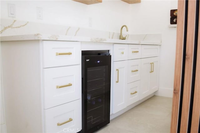 54889 Navajo Trl, Yucca Valley, CA 92284 - kitchen featuring wine cooler, white cabinets, light stone countertops, and light tile patterned floors
