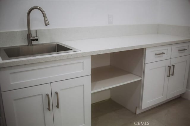 54889 Navajo Trl, Yucca Valley, CA 92284 - kitchen featuring open shelves, white cabinets, light countertops, tile patterned floors, and built in desk
