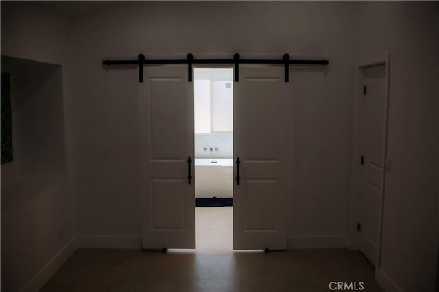 54889 Navajo Trl, Yucca Valley, CA 92284 - unfurnished room with a barn door and baseboards