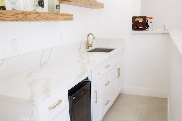 54889 Navajo Trl, Yucca Valley, CA 92284 - kitchen featuring wine cooler, light stone countertops, and white cabinets