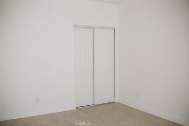 54889 Navajo Trl, Yucca Valley, CA 92284 - unfurnished bedroom featuring a closet and light colored carpet