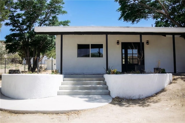 54889 Navajo Trl, Yucca Valley, CA 92284 - view of exterior entry with a porch and stucco siding
