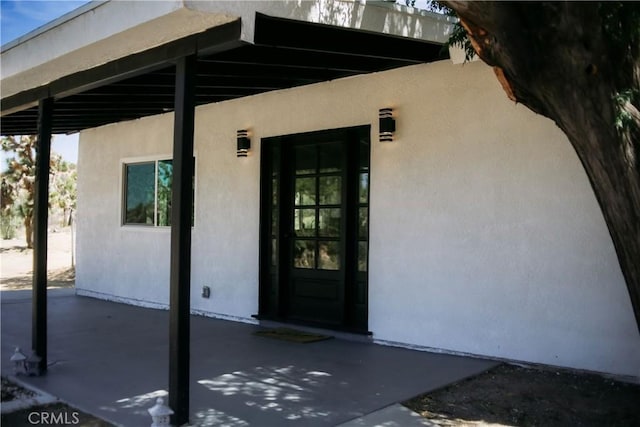 54889 Navajo Trl, Yucca Valley, CA 92284 - entrance to property featuring stucco siding and a patio