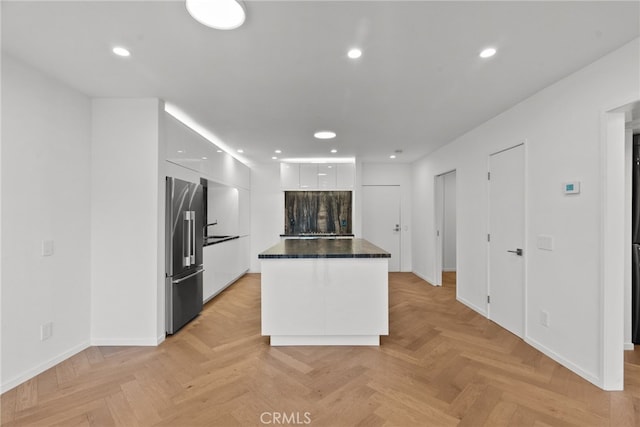 330 N Jackson St Unit 313, Glendale, CA 91206 - kitchen featuring freestanding refrigerator, modern cabinets, white cabinetry, dark countertops, and a kitchen island