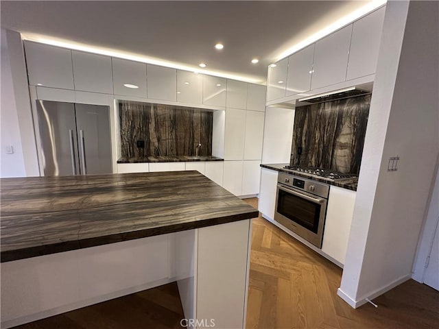 330 N Jackson St Unit 313, Glendale, CA 91206 - kitchen featuring stainless steel appliances, butcher block countertops, modern cabinets, white cabinets, and custom range hood