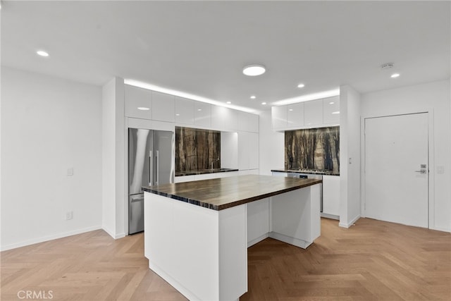 330 N Jackson St Unit 313, Glendale, CA 91206 - kitchen featuring modern cabinets, freestanding refrigerator, white cabinetry, wood counters, and recessed lighting