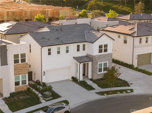 151 Fremont, Lake Forest, CA 92630 - view of front of home featuring concrete driveway, a garage, stucco siding, and stone siding