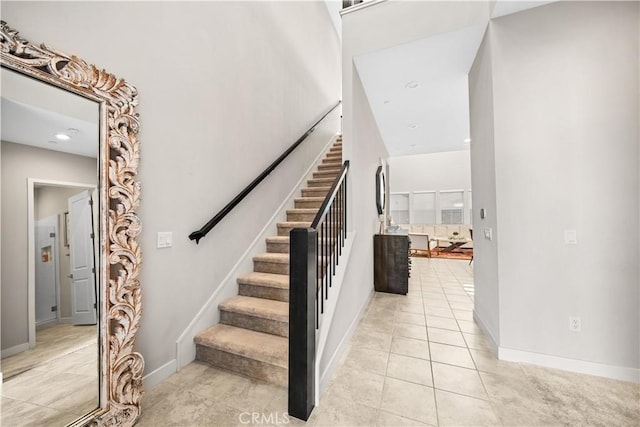 151 Fremont, Lake Forest, CA 92630 - stairway featuring tile patterned flooring, a towering ceiling, and recessed lighting